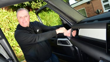 Land Rover Defender long-termer - Steve Fowler holding on to dashboard handle