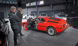 Auto Express consumer reporter Tom Jervis sitting in a BMW M1