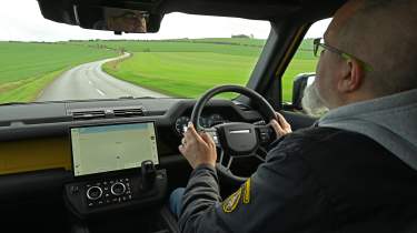Auto Express senior test editor Dean Gibson driving the Land Rover Defender 110 Trophy Edition