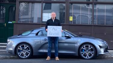 Steve Sutcliffe holding 'au revoir' sign