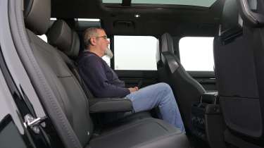Auto Express senior test editor Dean Gibson sitting in the Land Rover Defender OCTA Black's rear seat