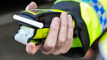 Police officer holding a breathalyser