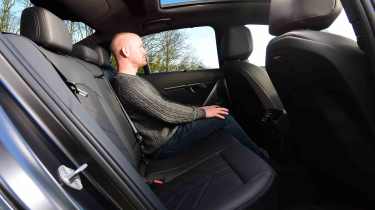 Auto Express contributor Alex Ingram sitting in the BMW i5's rear seat