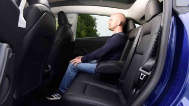 Tesla Model Y - rear seats with Chief reviewer, Alex Ingram